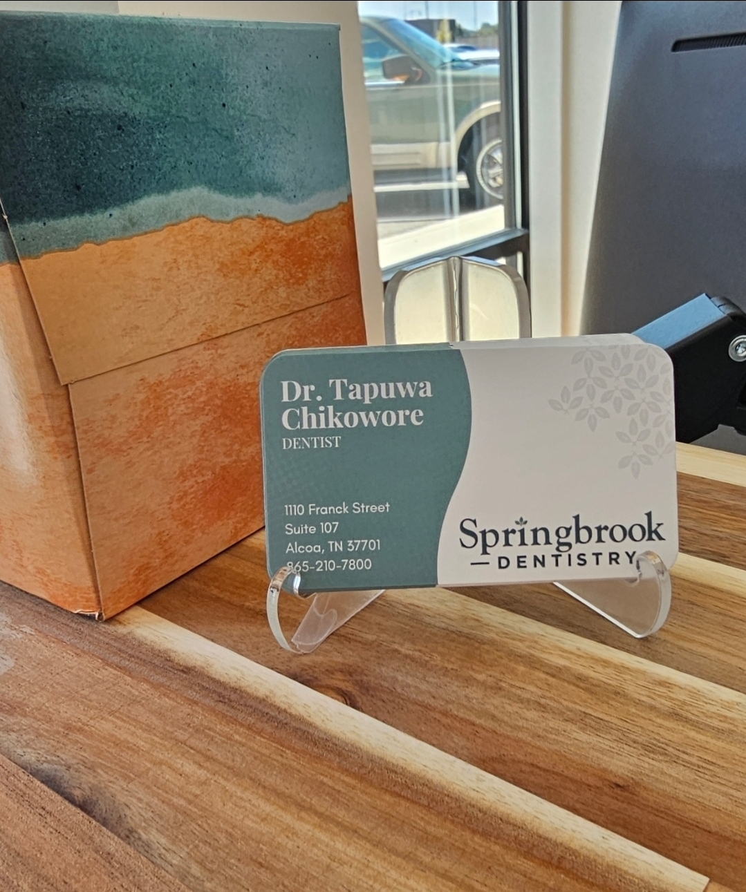 Dr. Chikowore business card display on wooden surface